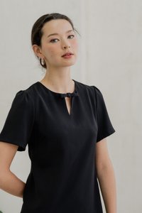 Britney Pleat Hem Bow Dress In Black (XS)