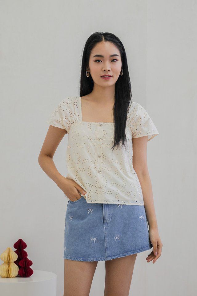 Evette Eyelet Ribbon Button Top In Cream